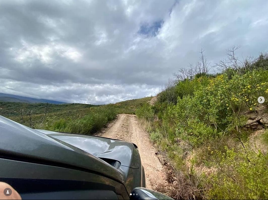 4x4 vehicle on a dirt trail through the hills