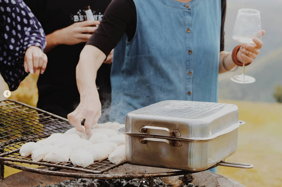 Braai cooking with wine in hand