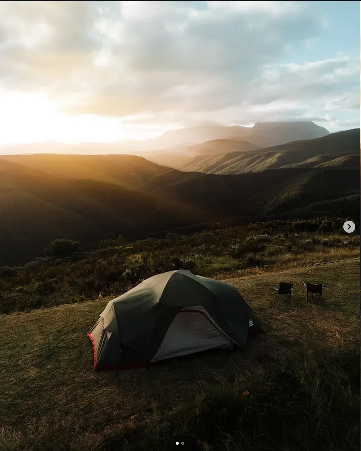 Tent overlooking mountains at sunrise at Wolkedans