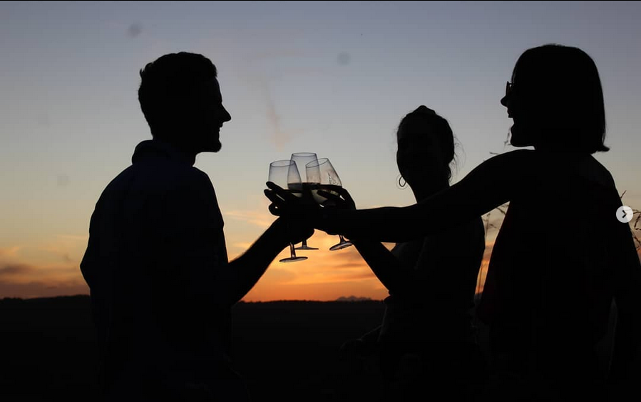 Silhouette of couple toasting at sunset