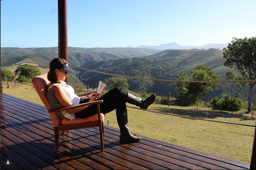 Relaxing on the deck with panoramic mountain views at Wolkedans